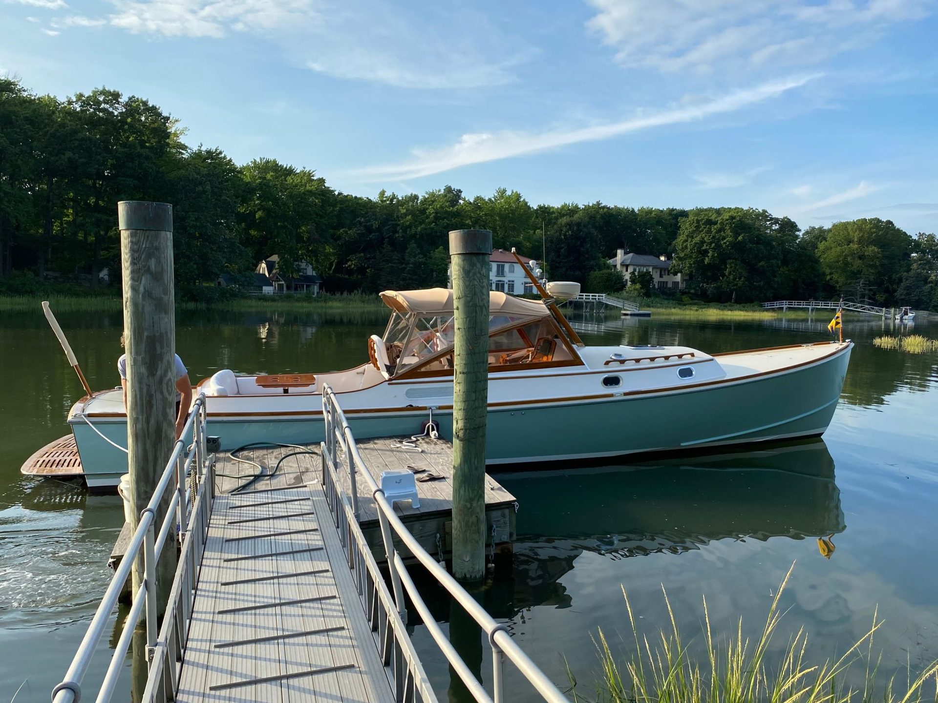 38' Shelter Island Runabout with teal hull, detailed and docked